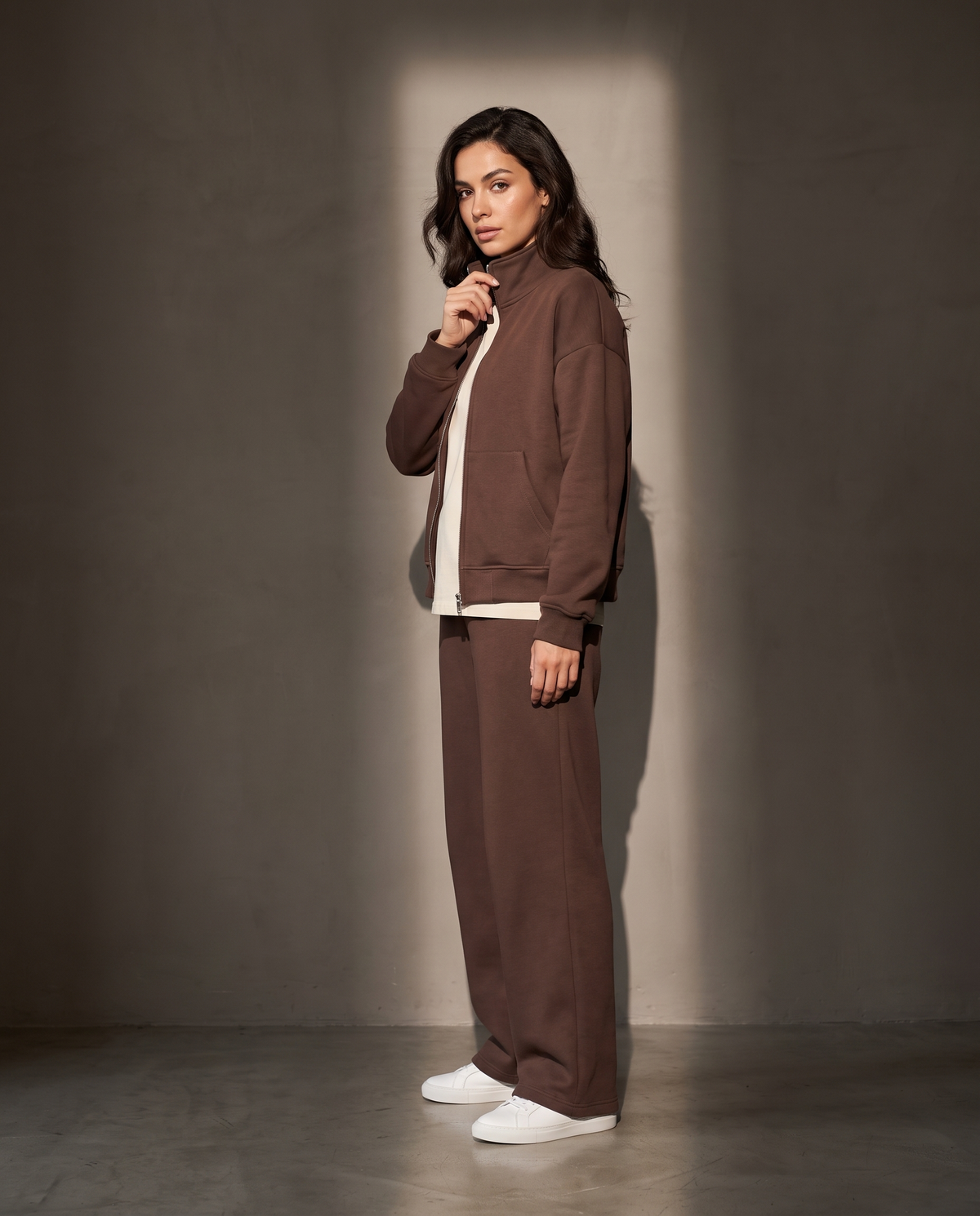 Elva Zip Set in profile against a warm greige wall