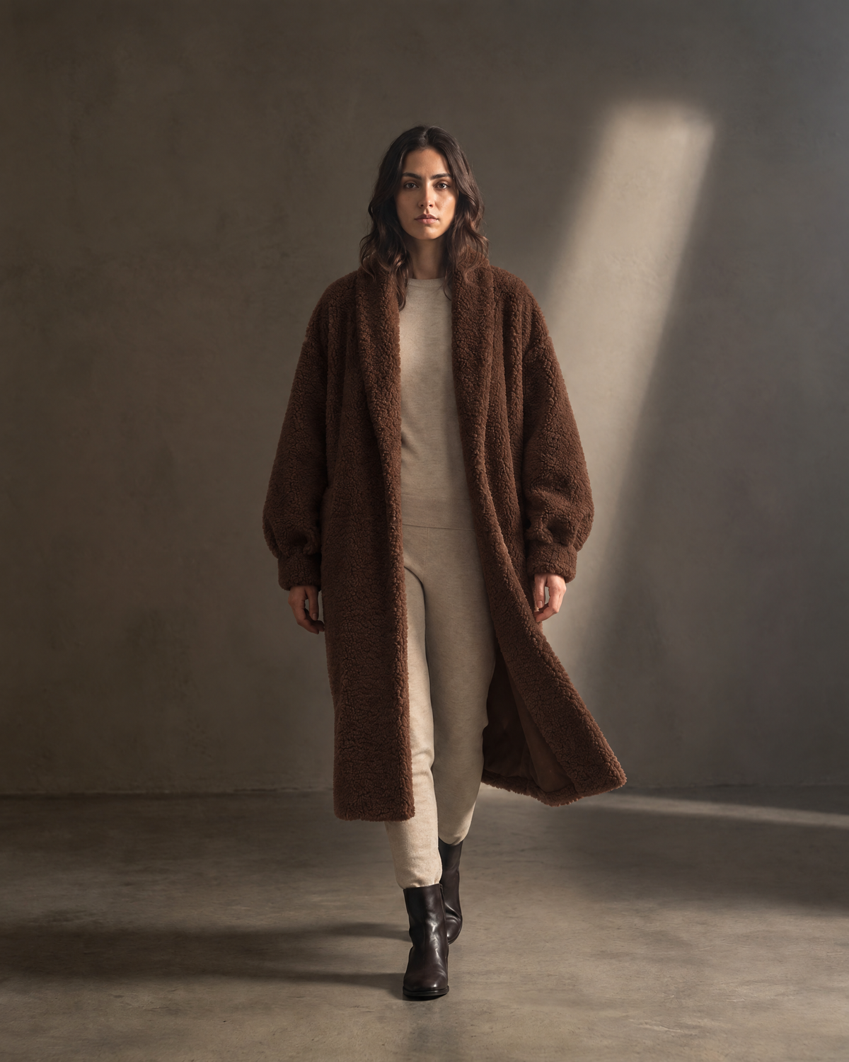 Auria Teddy Coat in chocolate, in movement against a warm greige wall