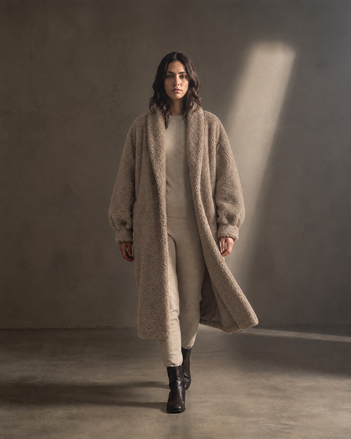Auria Teddy Coat in taupe, in movement against a warm greige wall